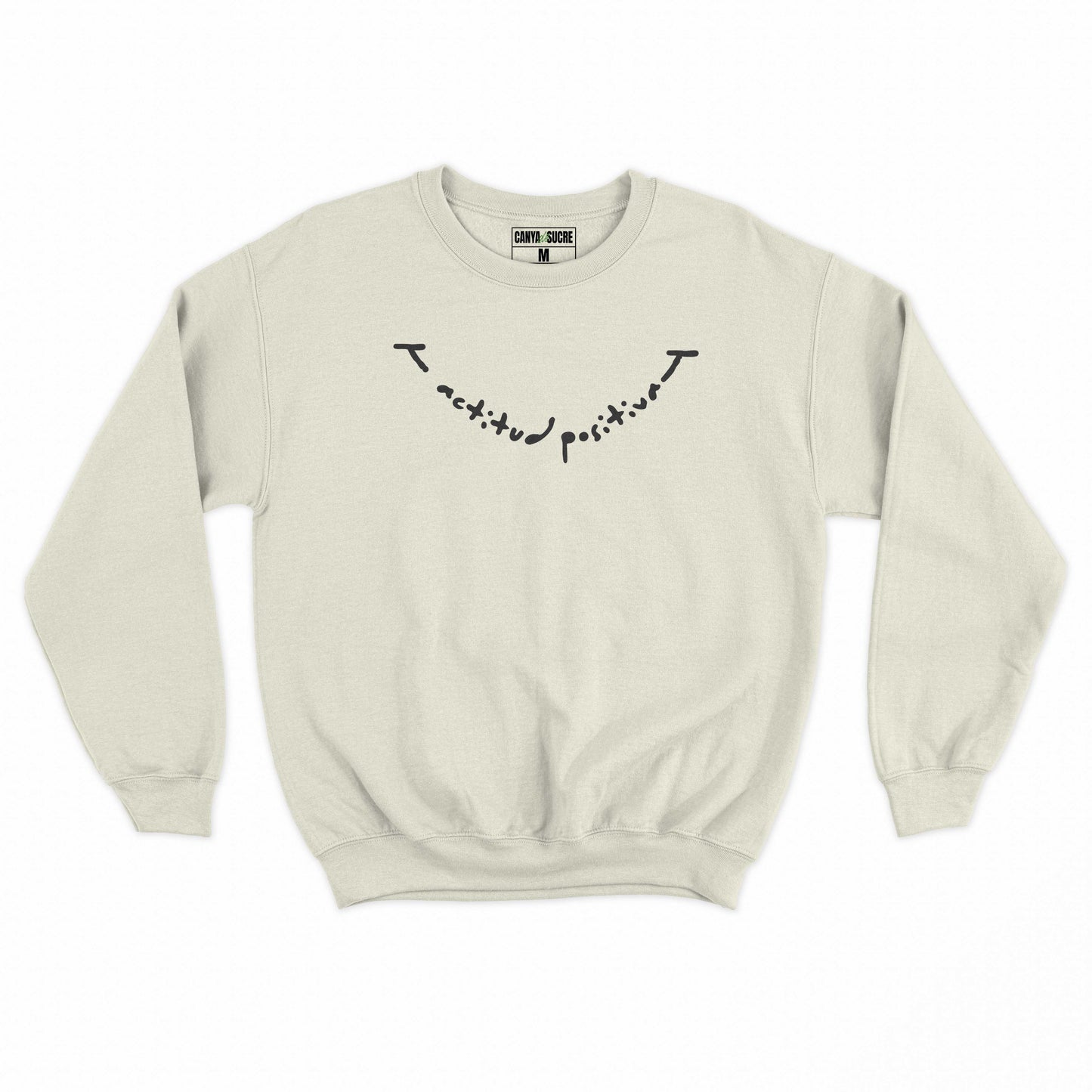 Dessuadora beige amb el missatge “actitud positiva” en lletra manuscrita negra —disseny original de Canya de Sucre.