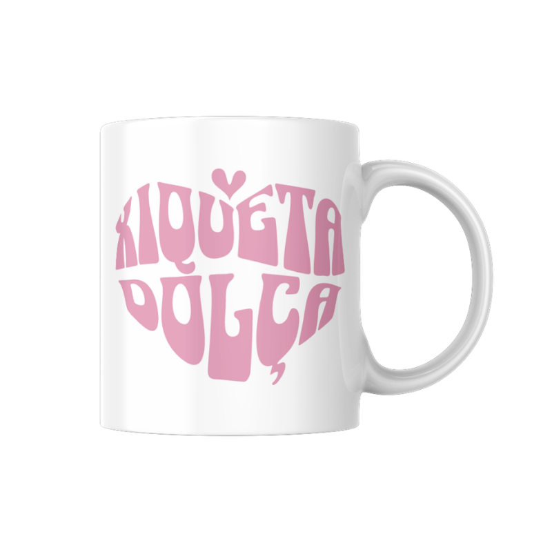 Tassa de ceràmica blanca amb la frase “Xiqueta dolça” en tipografia rosa formant un cor, disseny tendre en valencià de la marca Canya de Sucre.