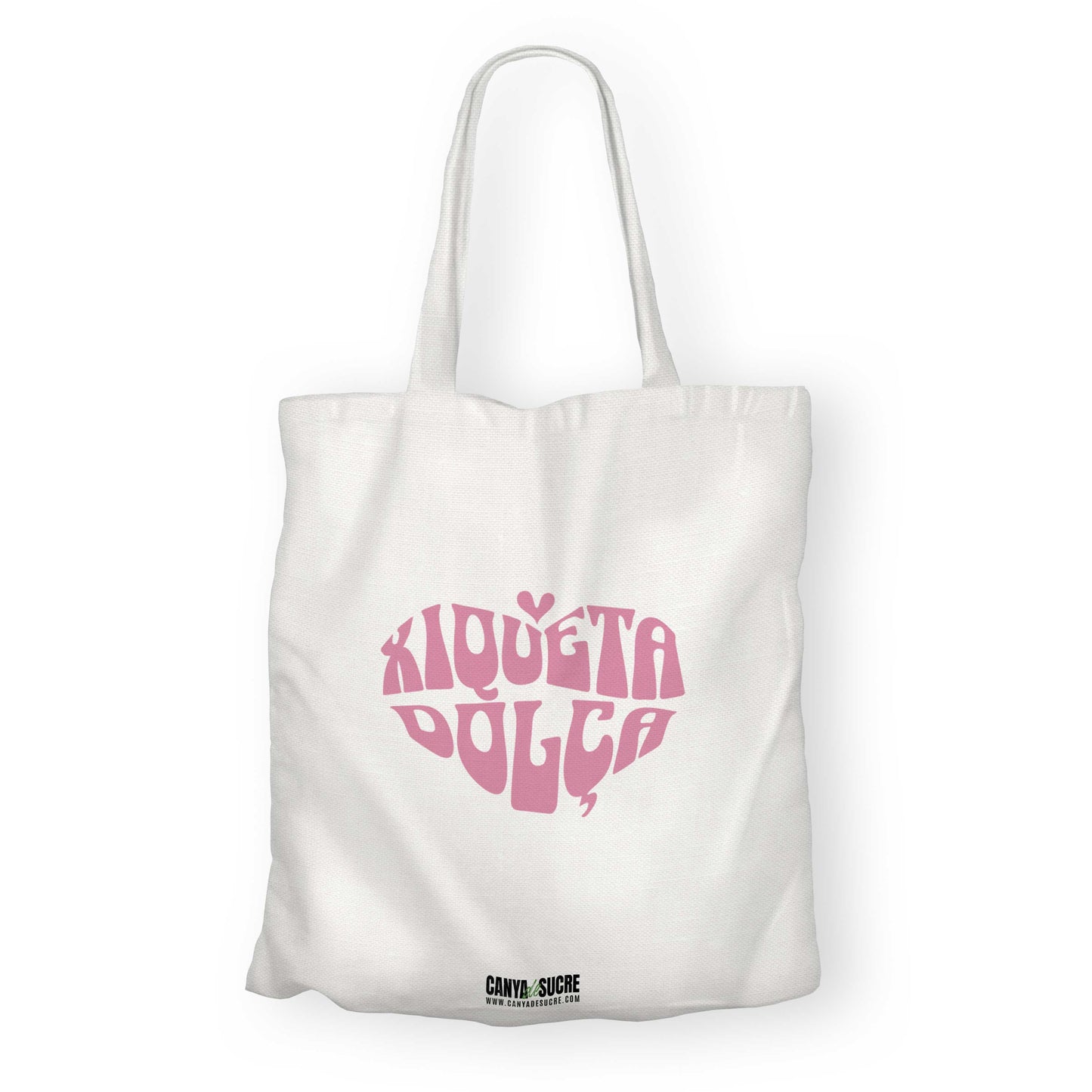 Totebag blanca amb disseny rosa en forma de cor amb el text “Xiqueta Dolça” de Canya de Sucre.